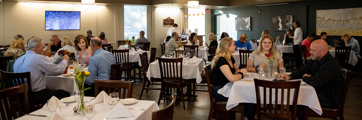 Guests enjoy dinner at the fully occupied 200 Monroe Restaurant dining room at Frederick Community College