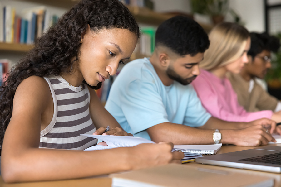 Student working through math problems with a calculator and notebook